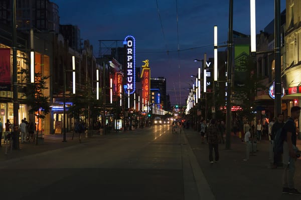 A view at night of Granville street in Vancouver with neon signs from the Orpheum theater and other businesses prominent