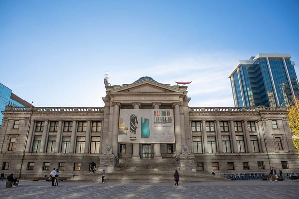 The front facade of the Vancouver Art Gallery with a banner for an exhibit that reads: Modern in the Making.